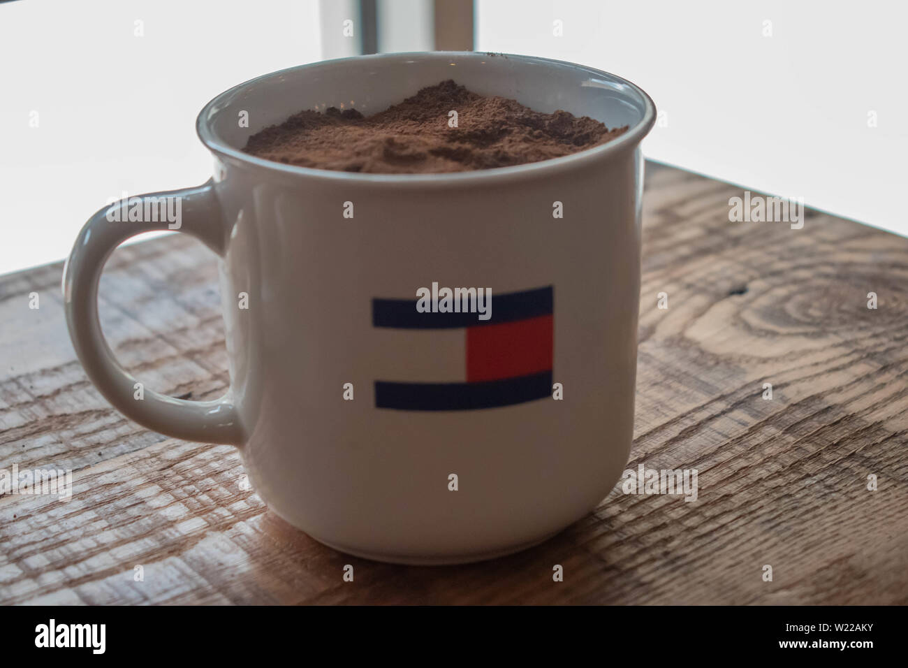 Orlando, Florida. June 6, 2019 . Tommy Hilfiger mug with ground coffee on  wooden rustic table at Premium Outlet in International Drive area Stock  Photo - Alamy