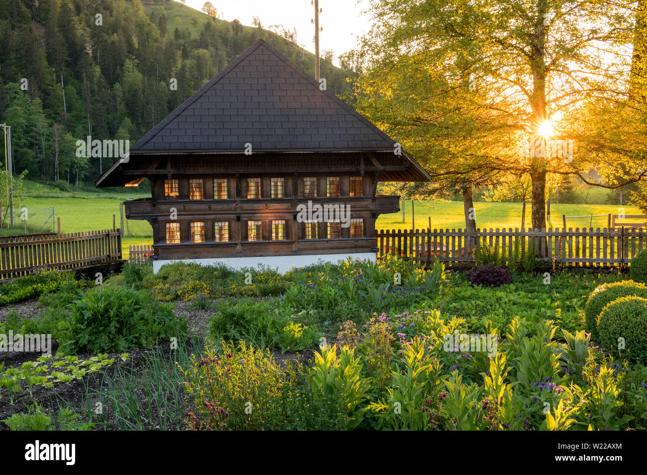 sunset behind a typical farmhouse in Emmental Stock Photo