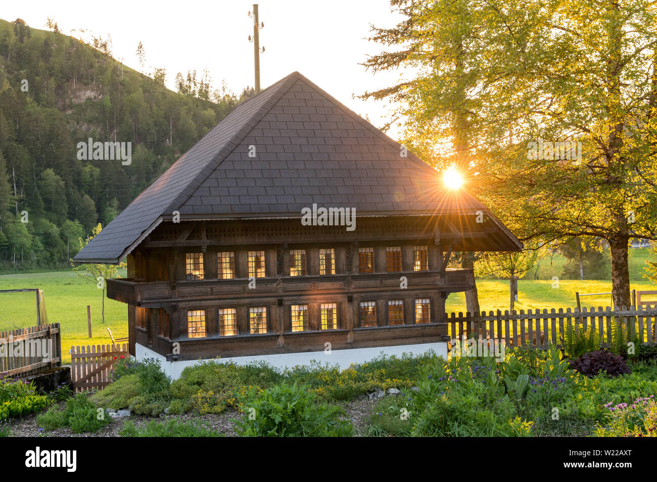 sunset behind a typical farmhouse in Emmental Stock Photo