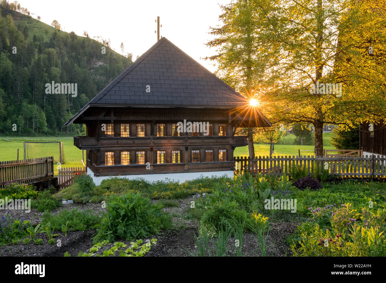 sunset behind a typical farmhouse in Emmental Stock Photo