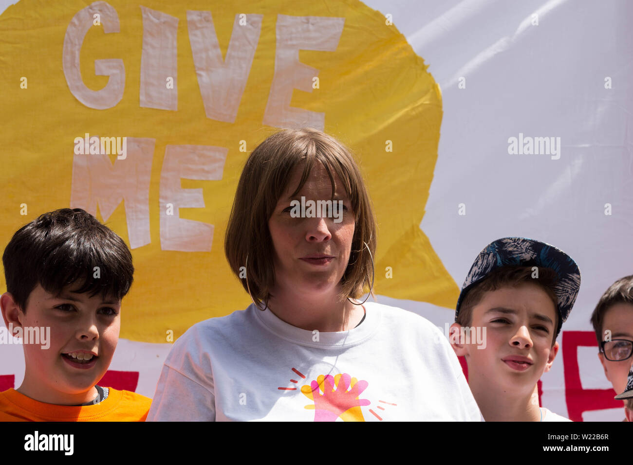 Parliament Square, London, UK. 5th July, 2019. Jess Phillips MP, parents and children protest over schools being forced to close early. The school Ms Phillips's children attend will be closing at lunchtime on Fridays from September because of funding cuts. Penelope Barritt/Alamy Live News Stock Photo