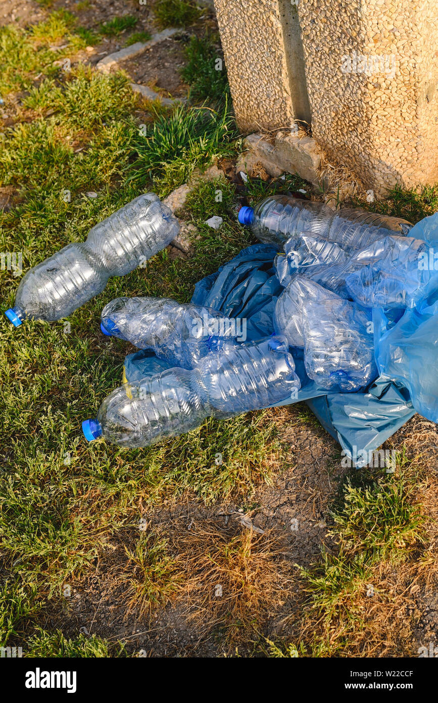 Plastic bottles bags on the grass. Plastic Waste In The Stock Photo - Alamy