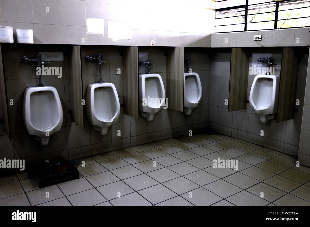 Photo of rows of urinals at a public restroom Stock Photo Alamy