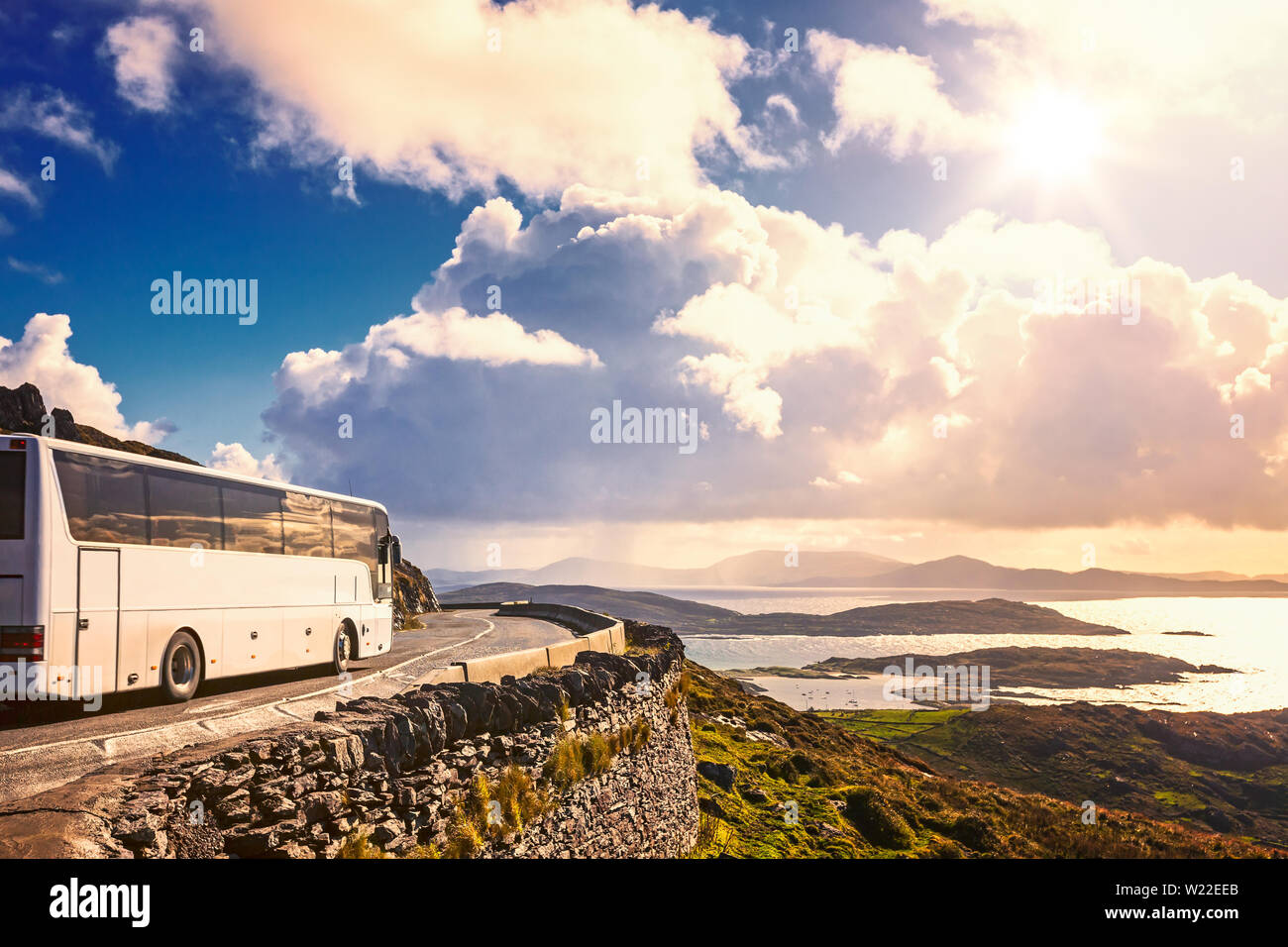 Tourist bus traveling on mountain road. Ring of Kerry, Ireland. Travel destination Stock Photo