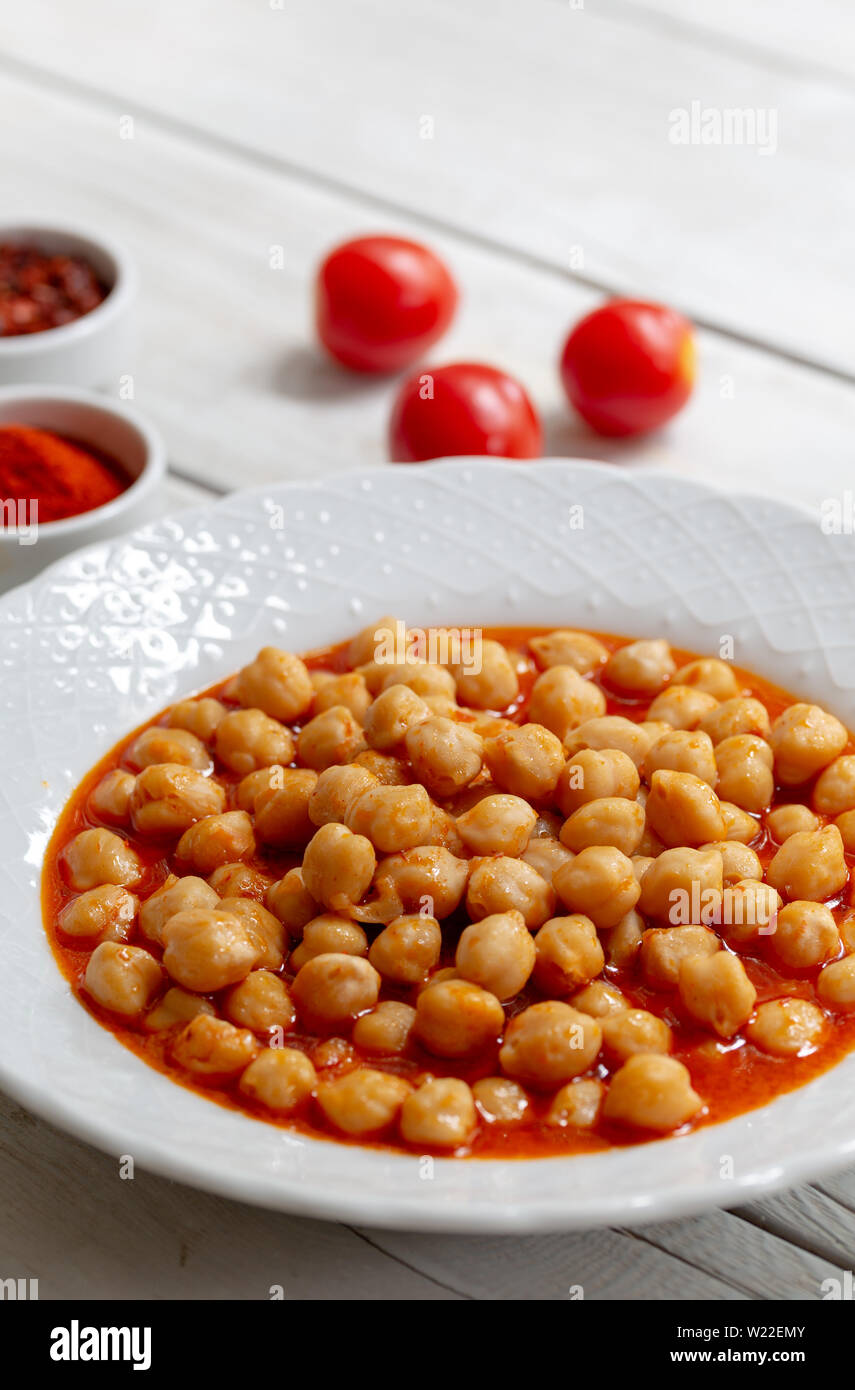 Vegetarian tasty spicy chick pea soup on a wooden background / Cheakpea stew/ Turkish nohut pilaki Stock Photo