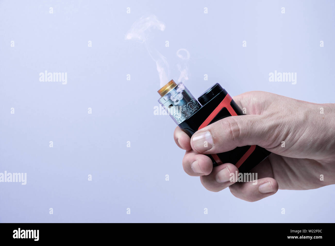 Vape mod e-cig for help quit smoking tobacco with atomizer rdta holding in hand Stock Photo