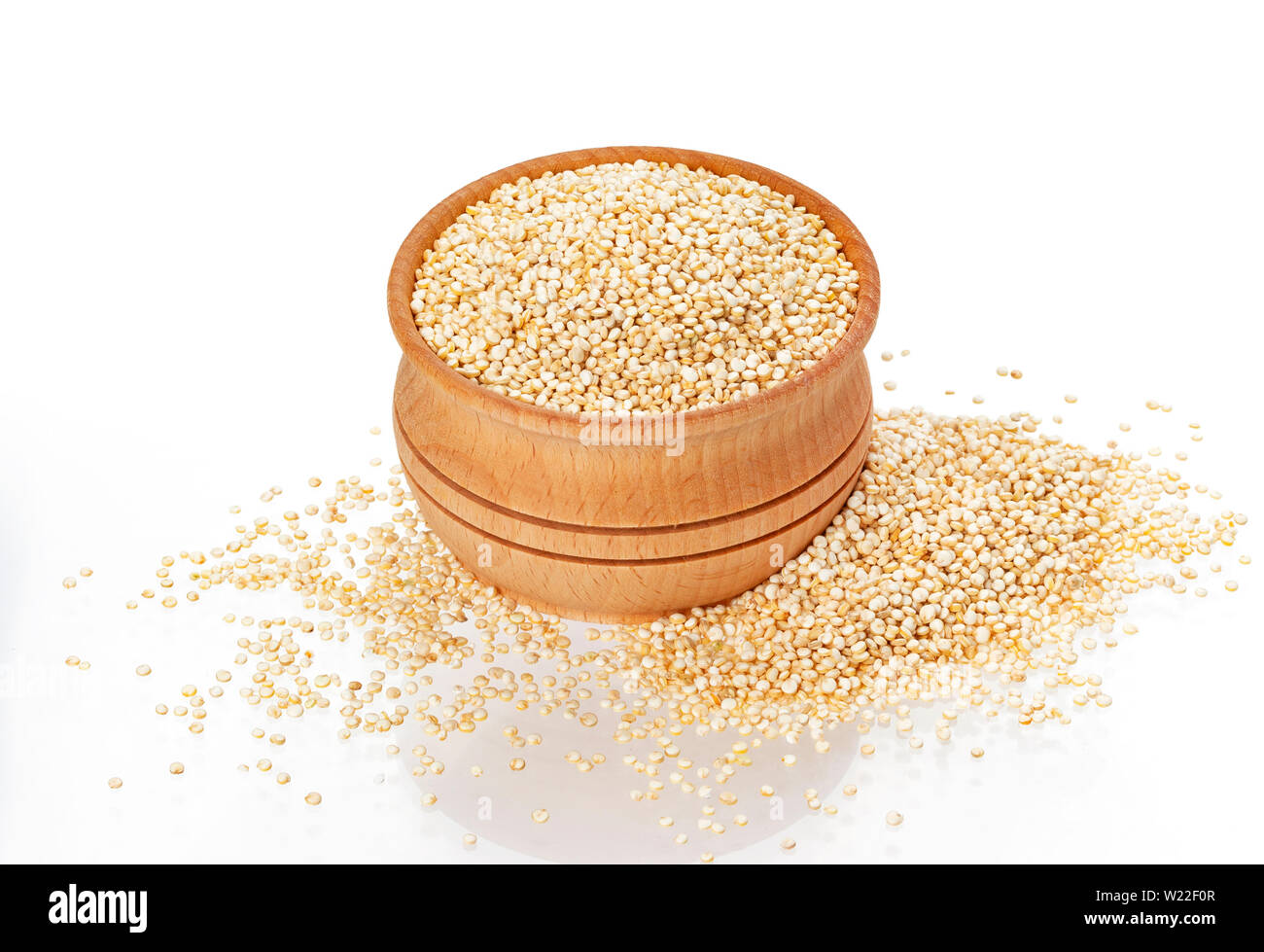 Wooden bowl of quinoa seeds isolated on white background Stock Photo