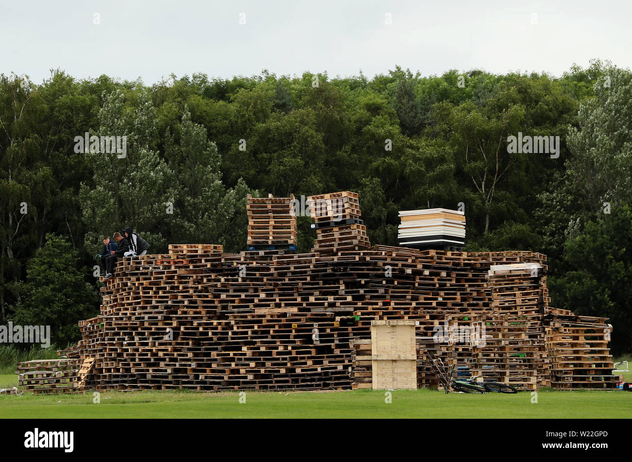 One of the contentious bonfires which is currently being erected at Inverary Playing Fields, as building continues on loyalist bonfires, which are traditionally lit on the 'Eleventh night' to usher in the Twelfth commemorations. Stock Photo