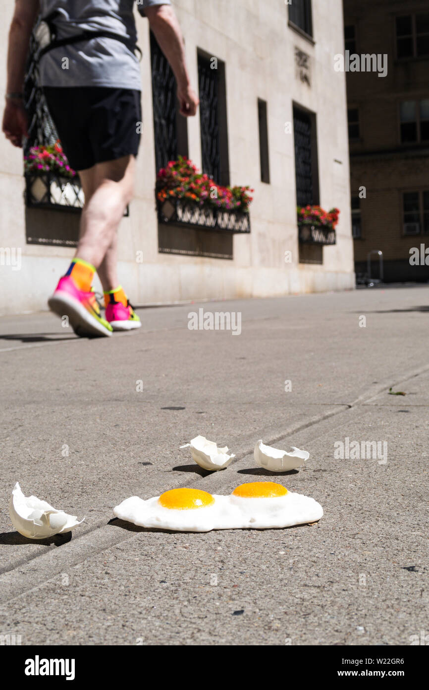 The expression "it's hot enough to fry eggs on a sidewalk" is used during a heatwave in New York City, USA Stock Photo