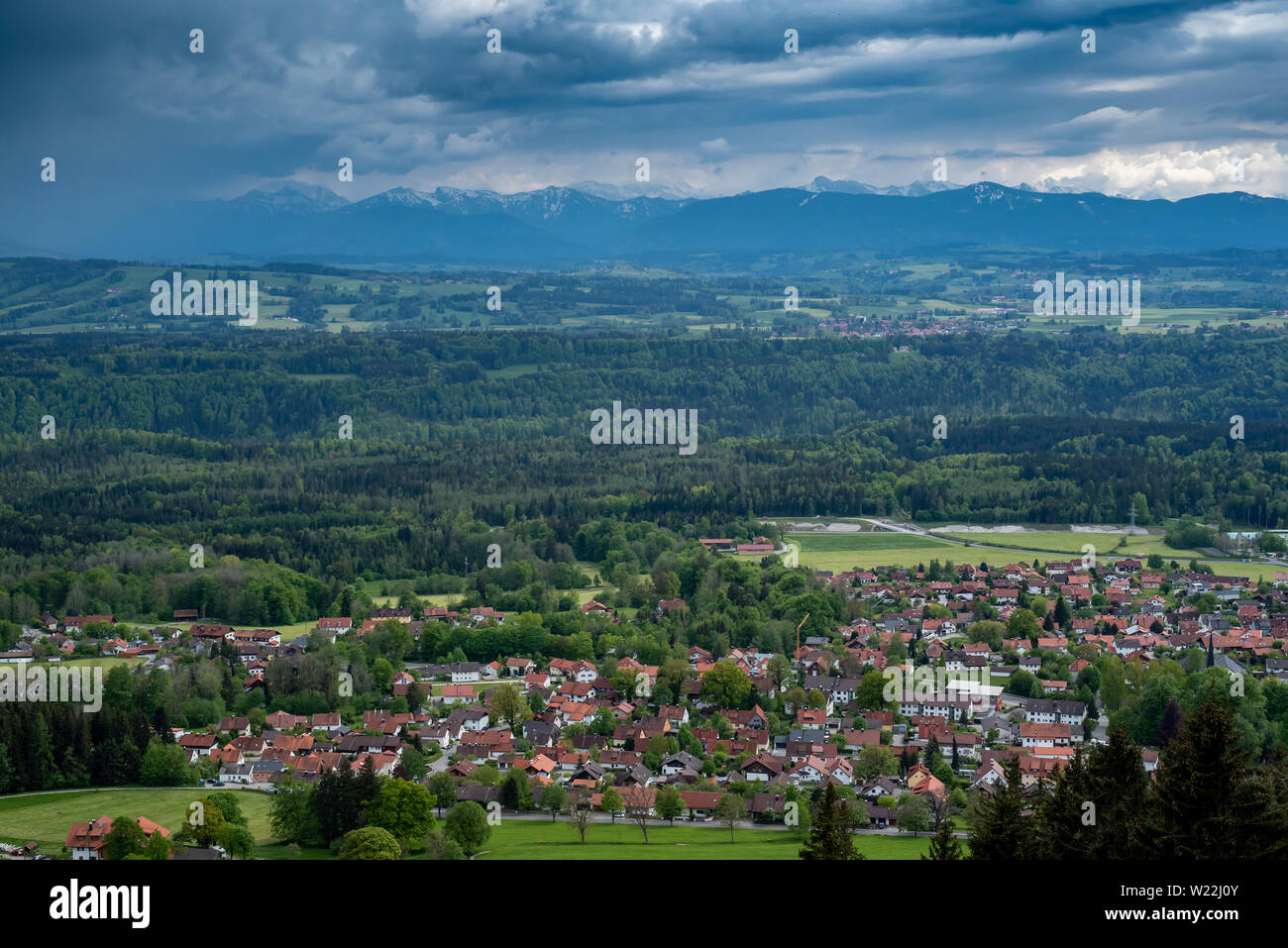 Hohenpeißenberg, Germany- May 19, 2019. Aerial view of the town of Peissenberg with the Alps in the background in the spring during the day , from Hoh Stock Photo