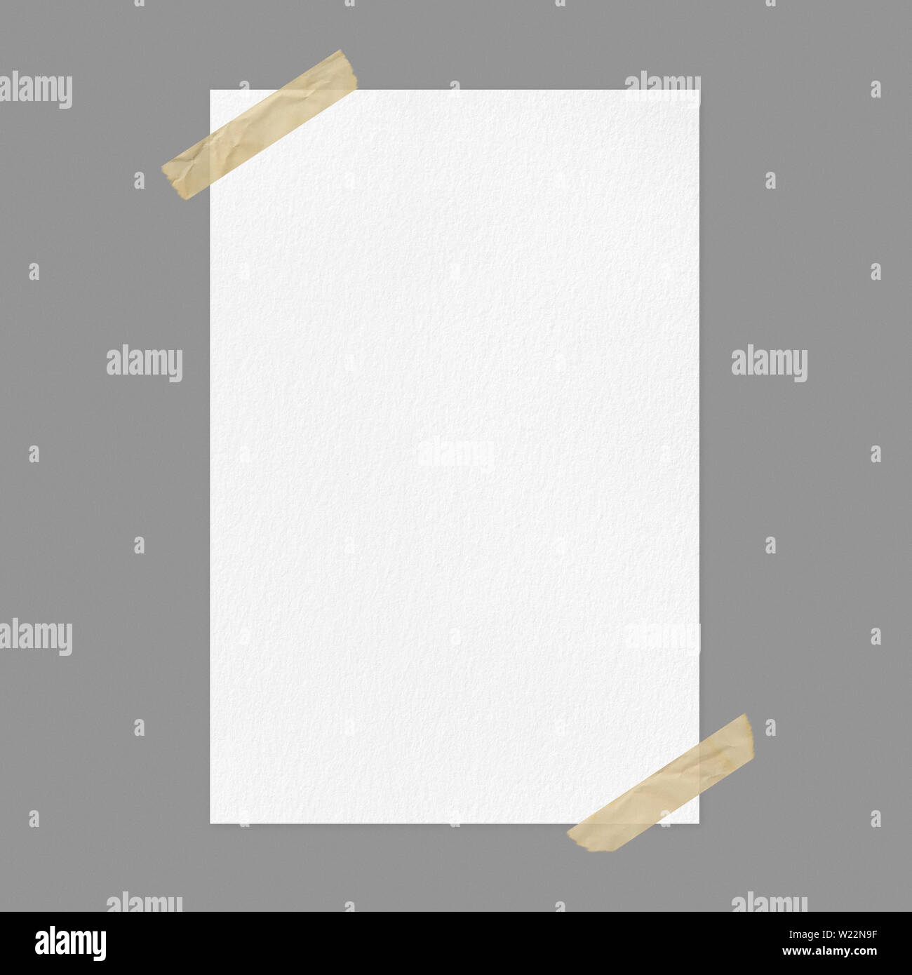 Blank white poster mockup on gray background, front view a4 paper sheet with adhesive tape and copy space Stock Photo