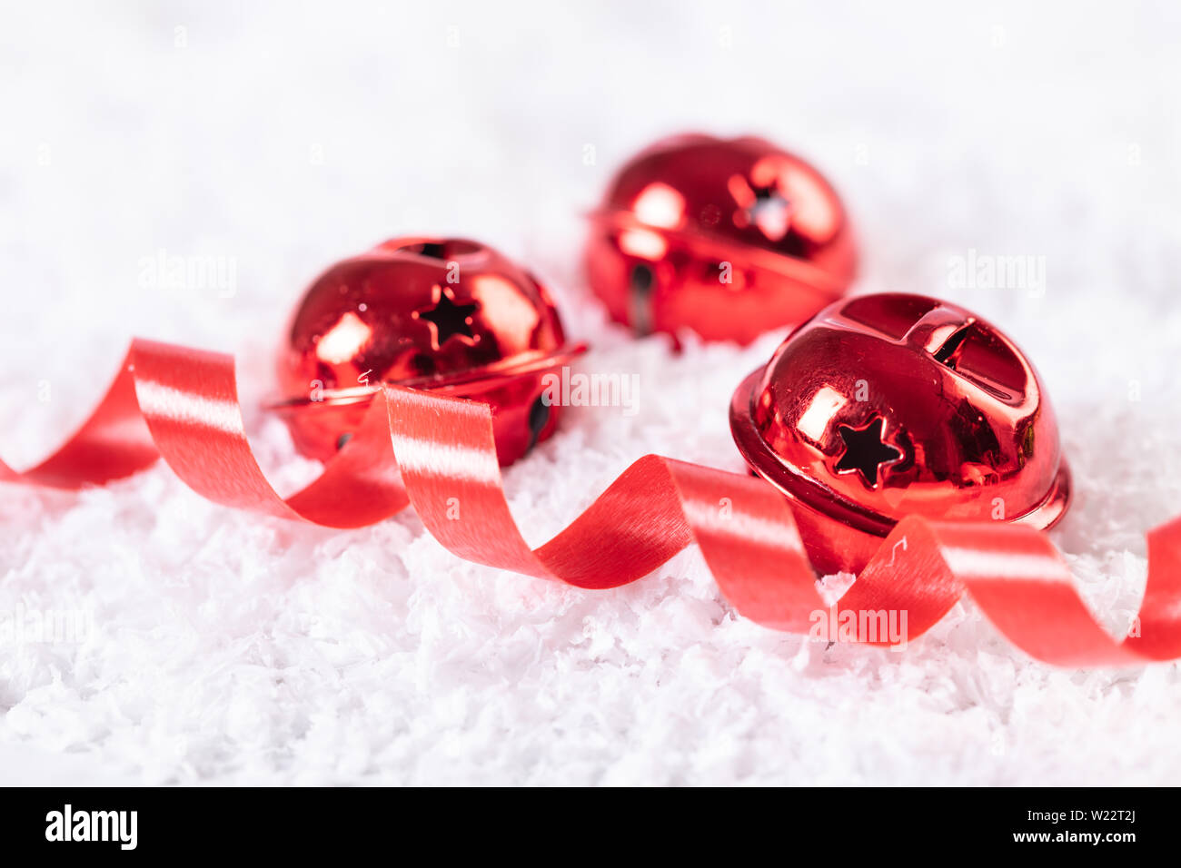 Christmas bells in the snow, festive background Stock Photo - Alamy