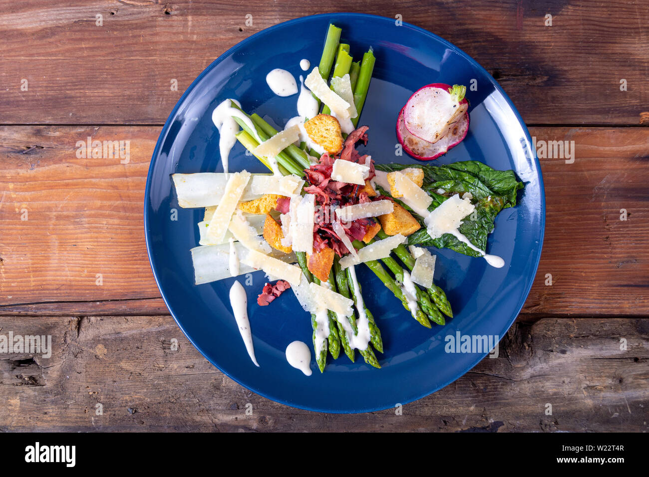 caesar asparagus with sliced parmesan cheese, smoked meat and crouton gourmet cuisine dish Stock Photo