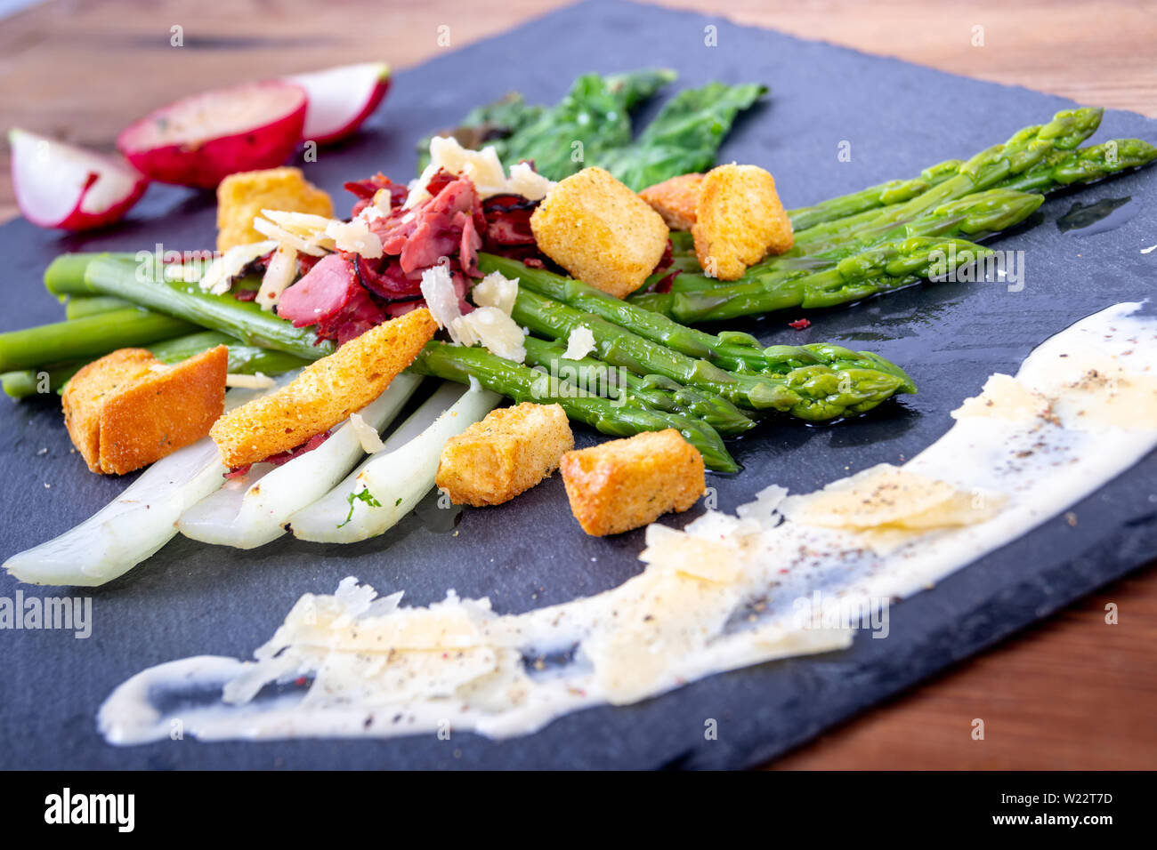 caesar asparagus with sliced parmesan cheese, smoked meat and crouton gourmet cuisine dish Stock Photo