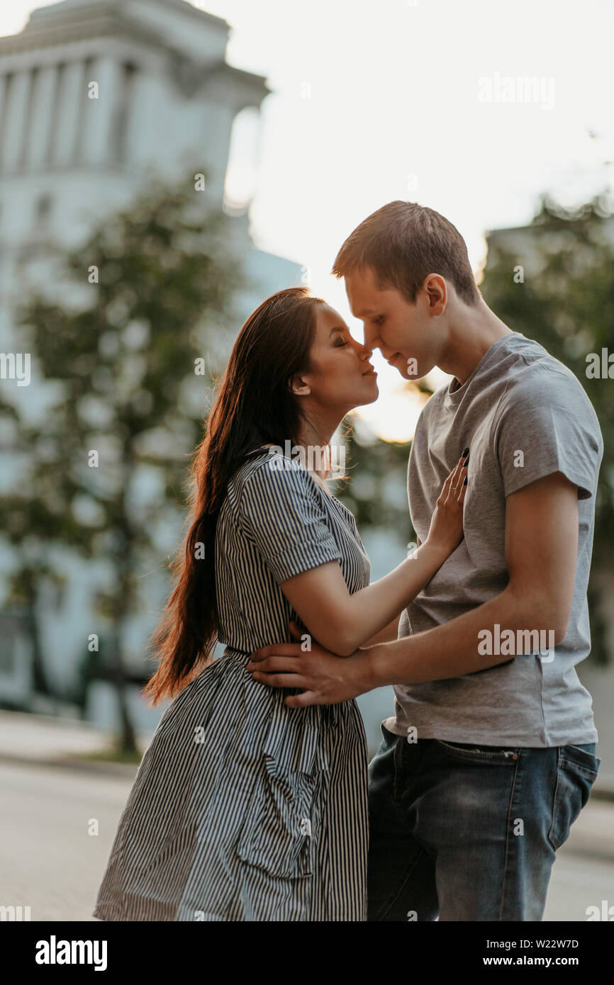 Young couple in love teenagers dressed in casual style walking together and  kissing on the city street Stock Photo - Alamy