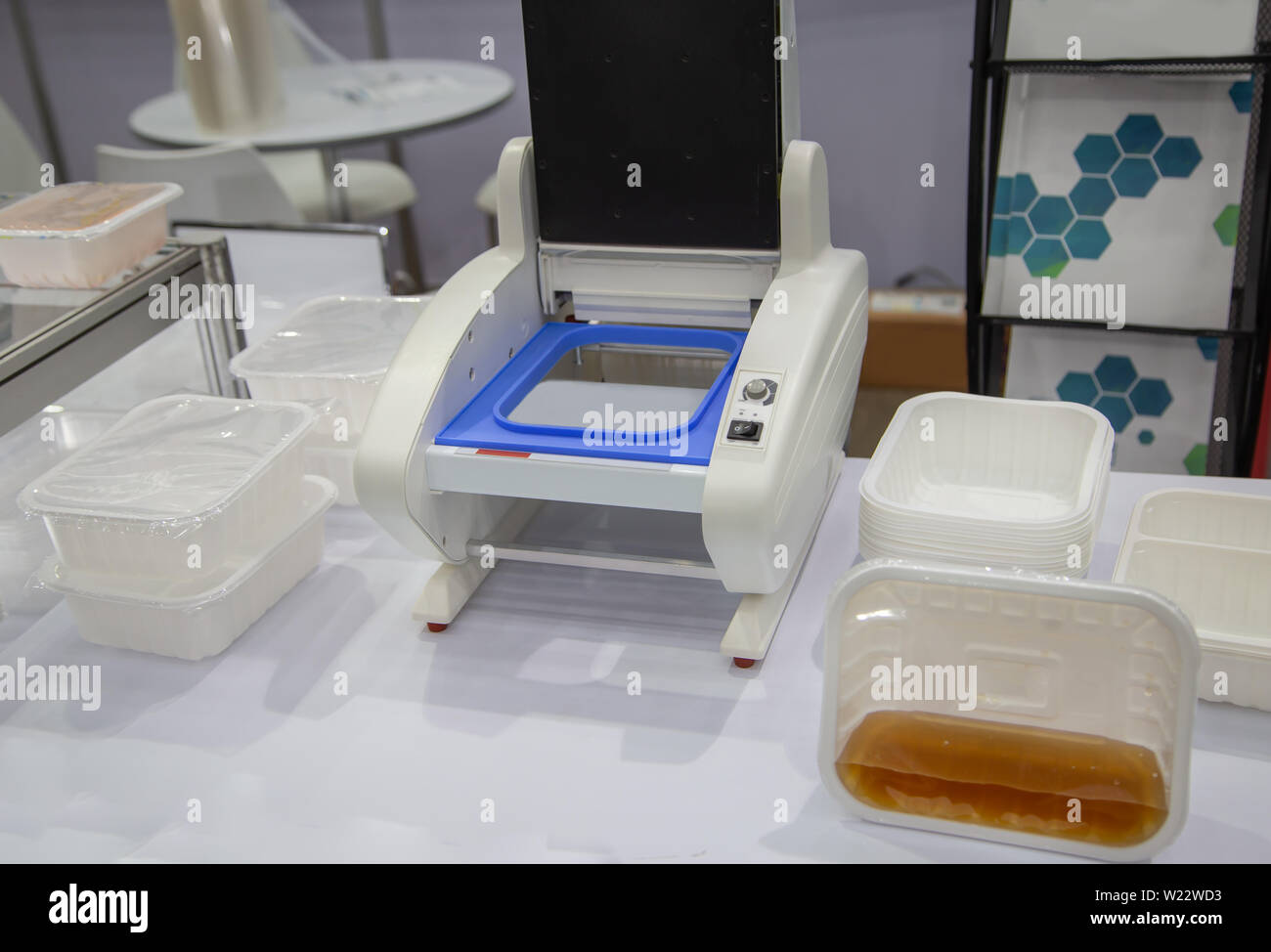 Food cup heat sealing and packaging machine Stock Photo - Alamy
