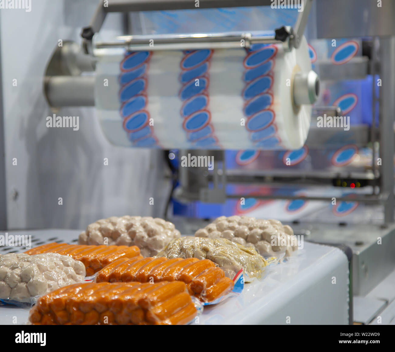 Linear tray food heat sealing and packaging machine Stock Photo - Alamy