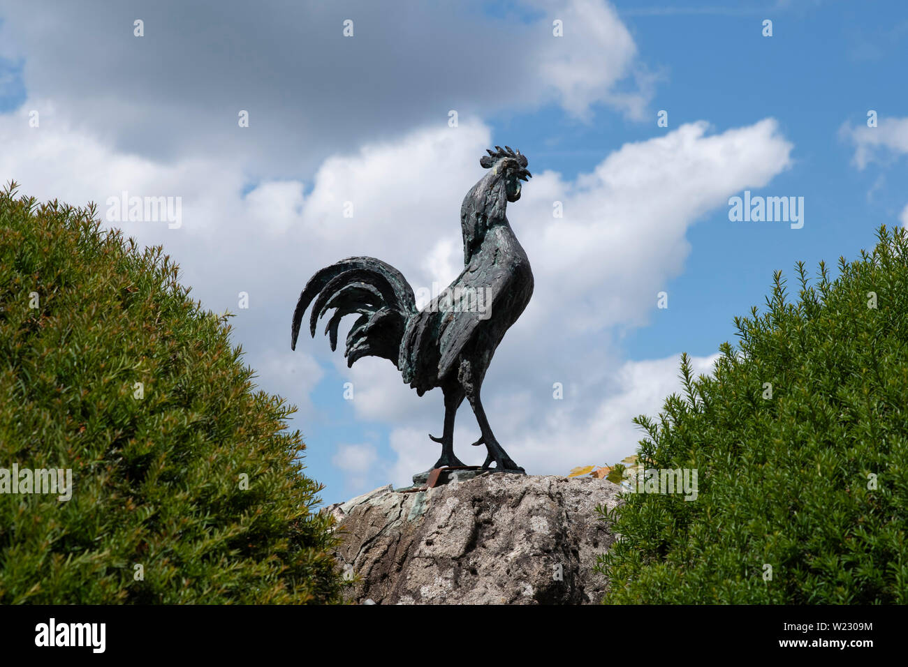 Statue of a rooster in front of a town hall in France Stock Photo