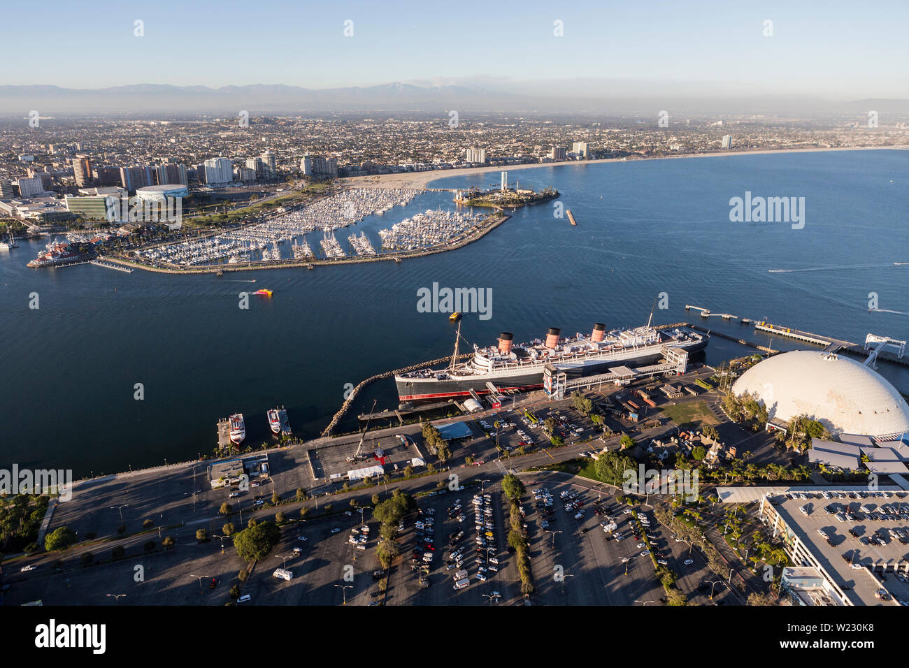 Long Beach, California, USA - August 16, 2016:  Aerial view of the Queen Mary, cruise ship terminal dome and downtown waterfront. Stock Photo