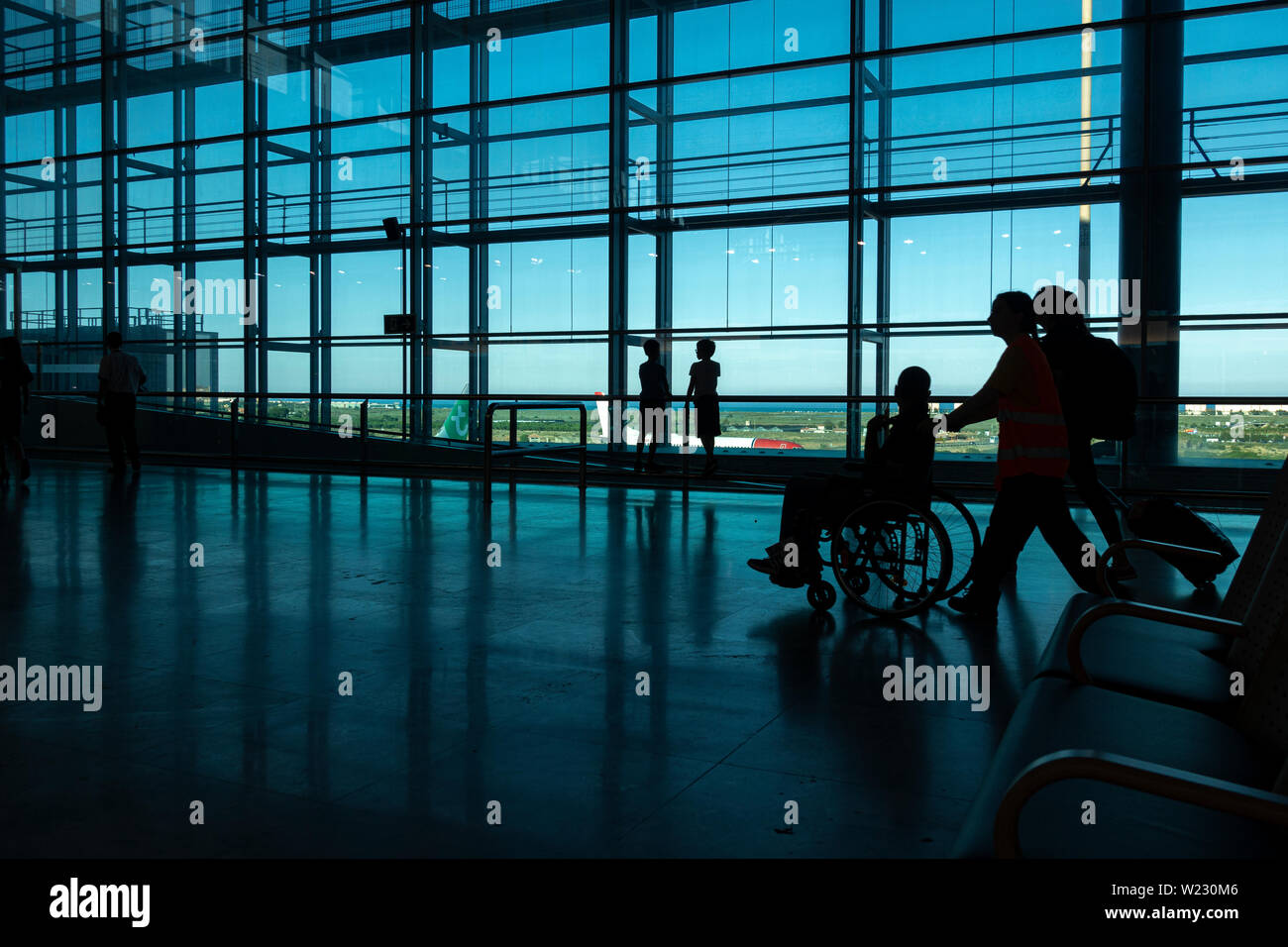 Alicante, Spain - 11 June, 2019: Silhouette of Passengers at Departure Terminal in Alicante International Airport Stock Photo