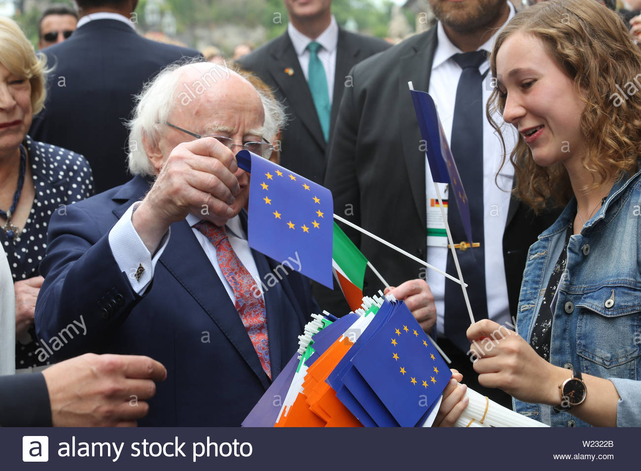 Würzburg, Germany. 05th July, 2019. Irish president Michael D Higgins picks an EU flag from a bunch offered to him by a well-wisher .He has visited Würzburg in Bavaria today on the last leg of his diplomatic trip to Germany. Earlier in the week he met Angela Merkel and German President Frank Steinmeier. President Higgins stopped at the university library this afternoon to view treasures of Irish literature and art, in particular the work of the famous German philospher, linguist and Latin scholar Casper Zeuss whose book Grammatica Celtica first documented the grammar of the Irish language. Stock Photo