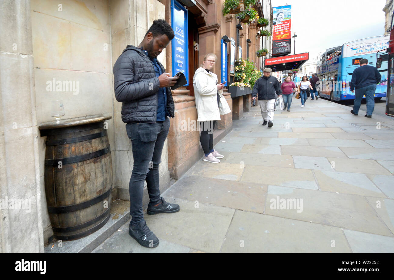 London, England, UK. People on their mobile phones in Whitehall Stock Photo