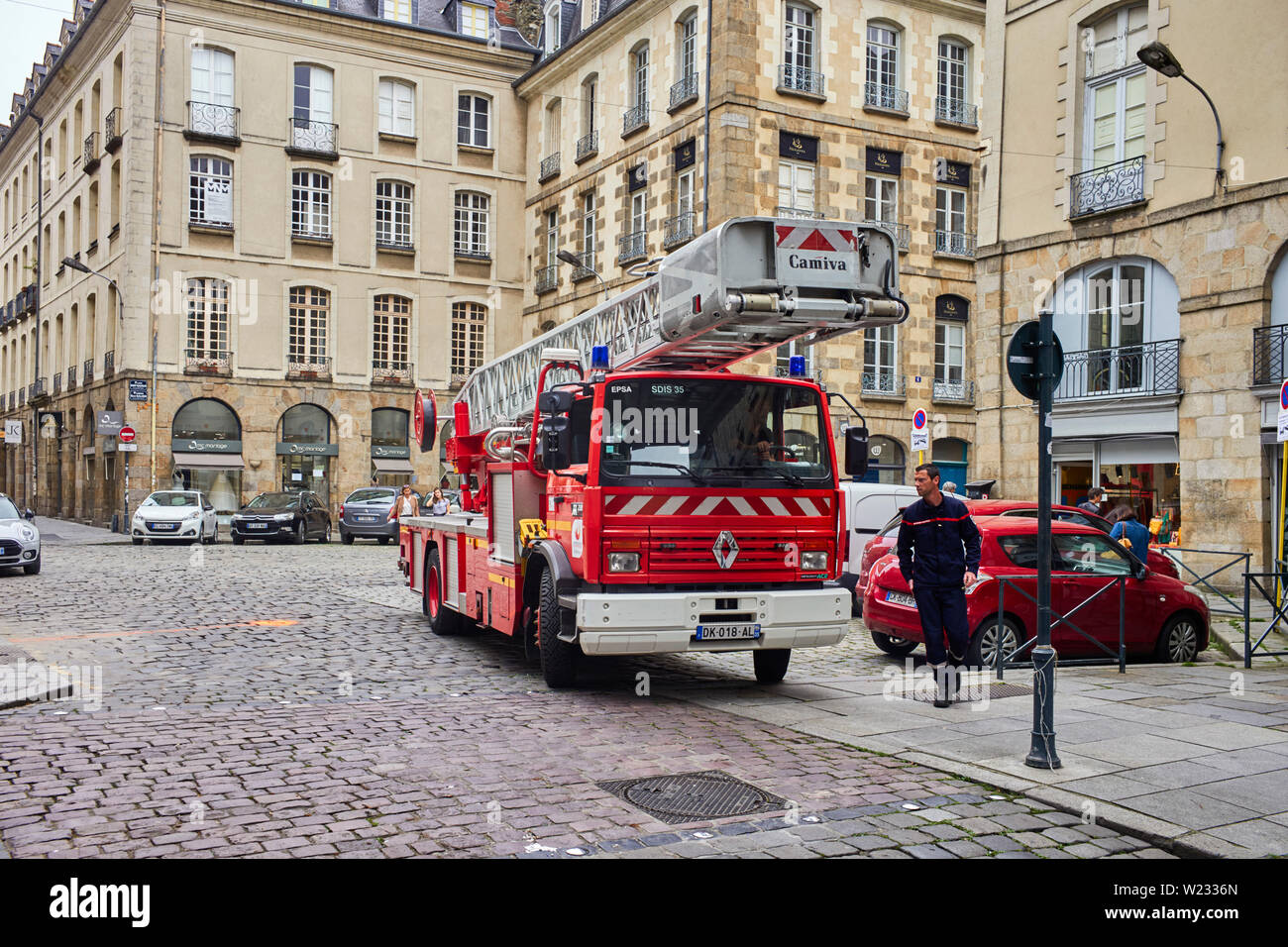 A large turntable fire engine in the narrow streets of Rennes the capital of Britanny, France Stock Photo