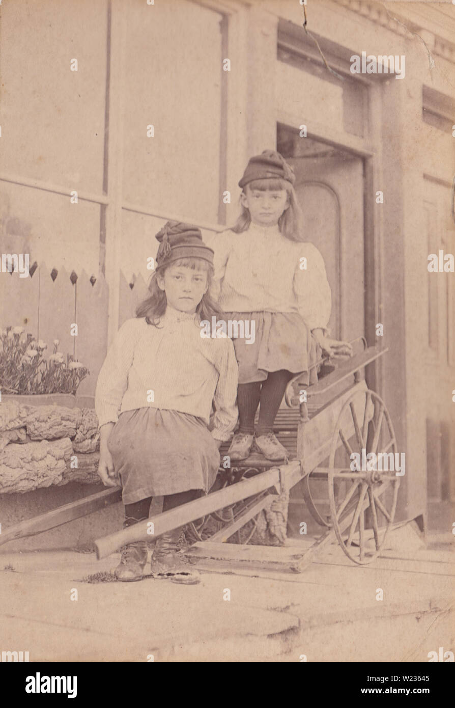 Victorian Photograph of Two Children Sitting on a Hand Cart Outside Ocean View, Borth, Wales. Photo Taken in The Summer of 1890 Stock Photo