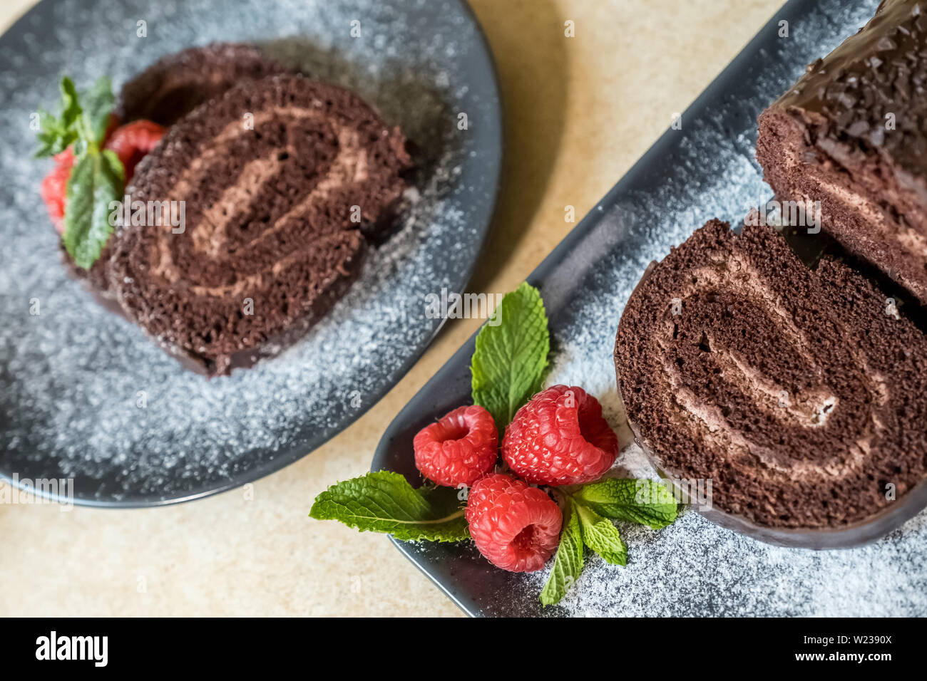 Chocolate Swiss Roll With Jam Decorated With Raspberries On A
