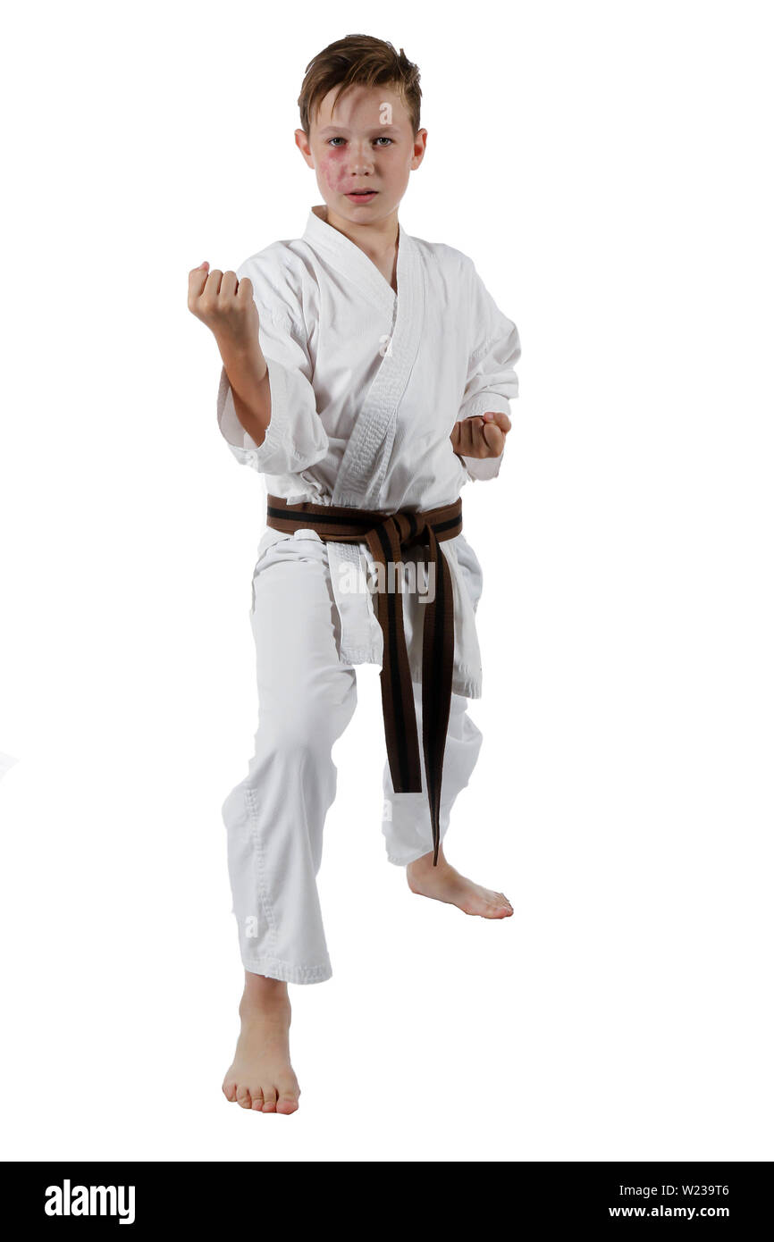 Teenage caucasian boy wearing a karate uniform doing karate Stock Photo