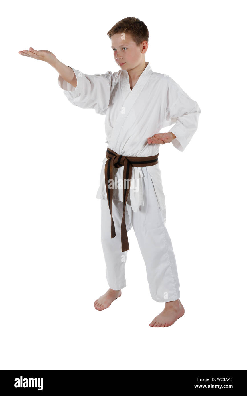 Teenage caucasian boy wearing a karate uniform doing an outside knife