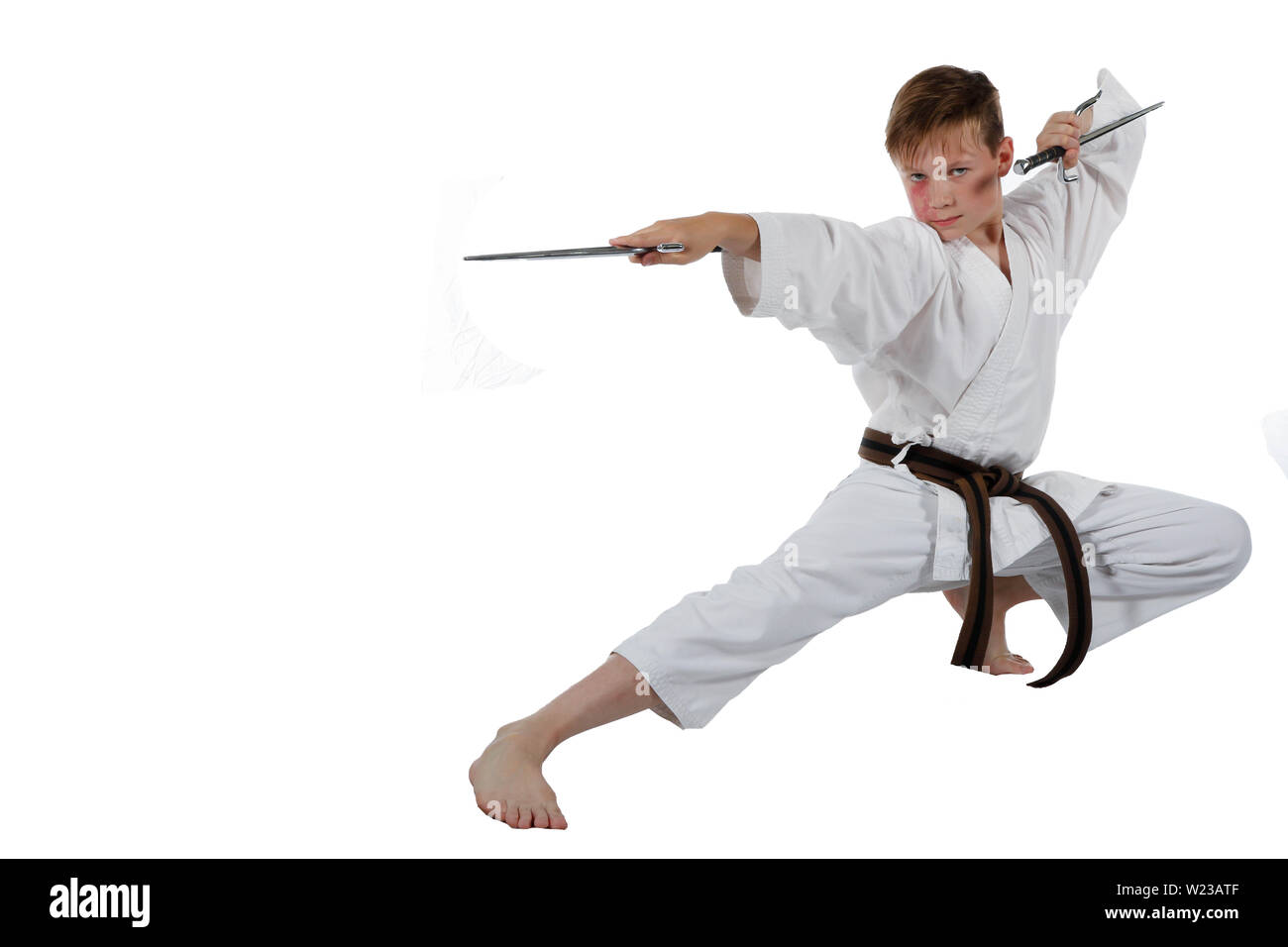 Teenage caucasian boy wearing a karate uniform performing kata with Sai  Stock Photo - Alamy