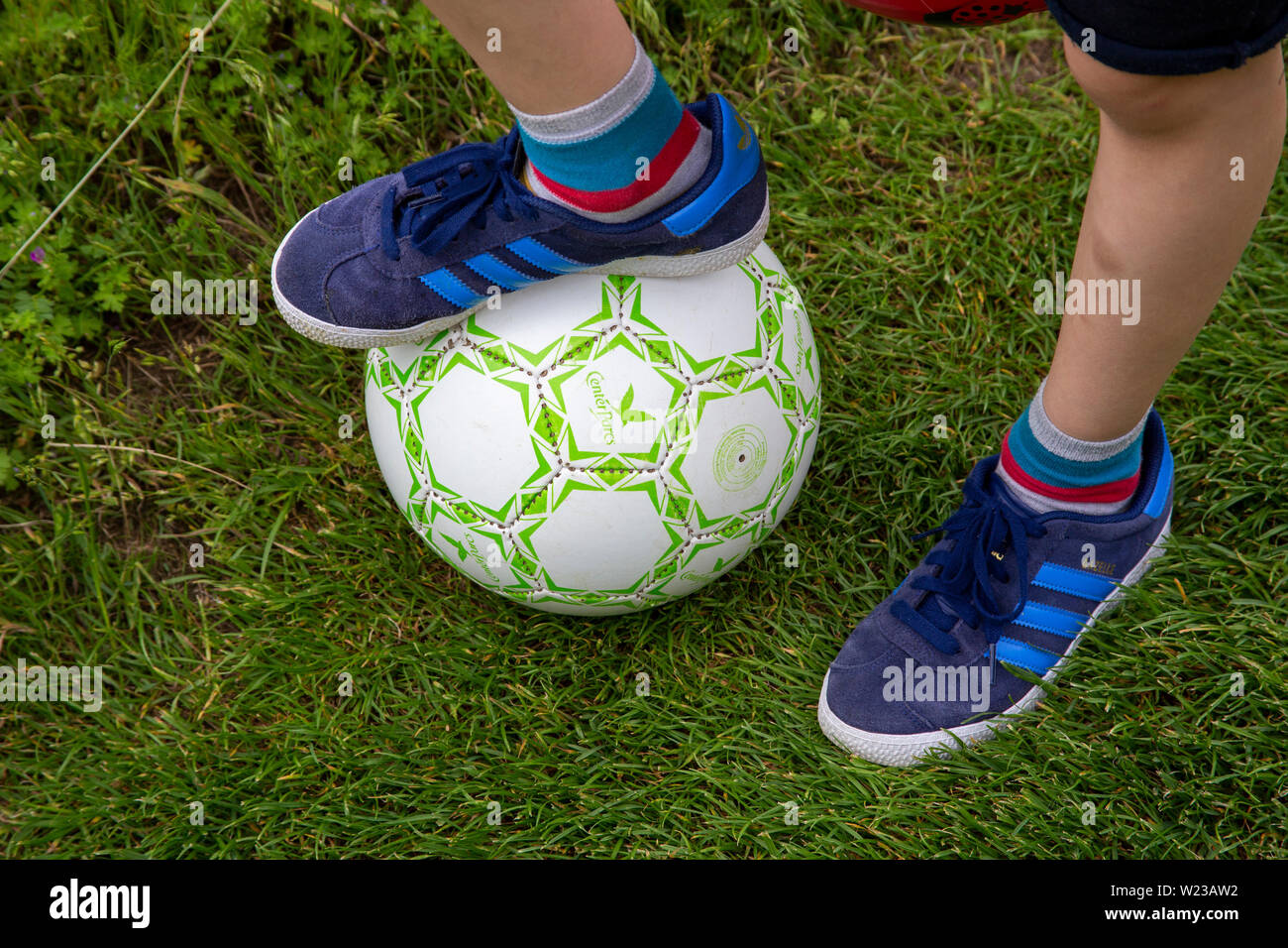 Child's feet with football Stock Photo