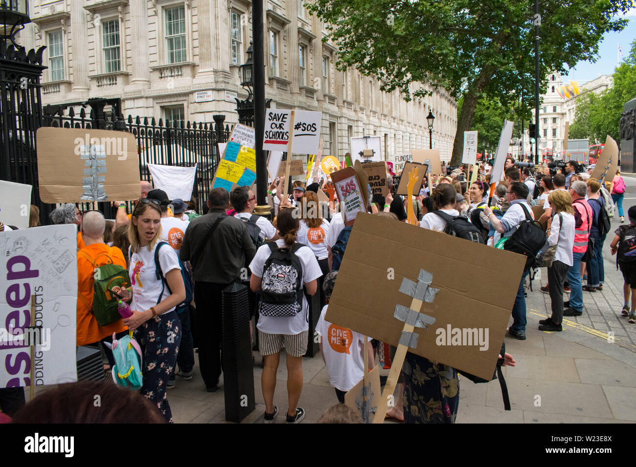 School children and teachers march on no.10 Downing street to protest against school cuts and schools opening only for 4 1/2 days a week. Stock Photo