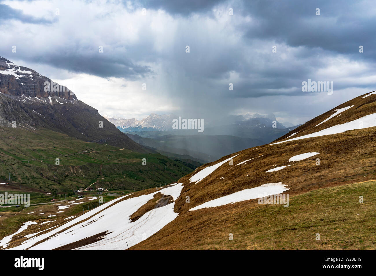 Great rain from a large cloud between mountains. Area Passo Pordoi. Dolomites Stock Photo Alamy