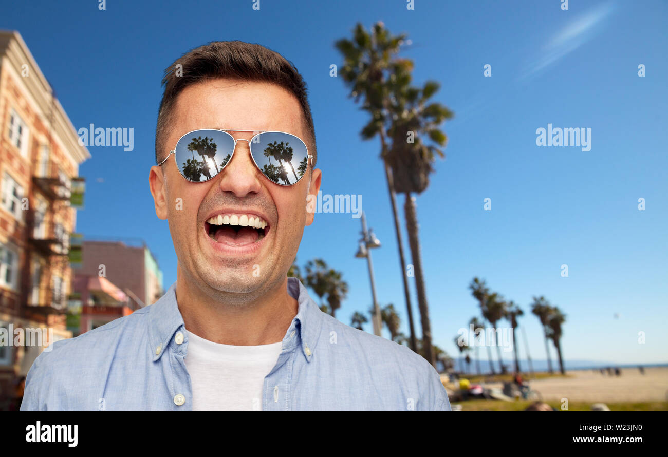 laughing man in sunglasses over venice beach Stock Photo Alamy