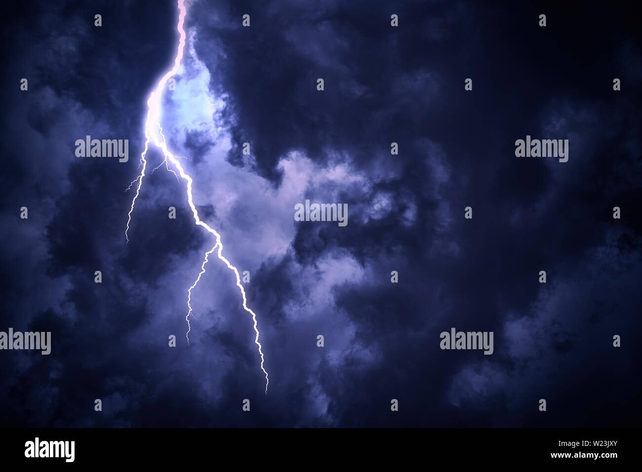 Lightning strike on a cloudy dark sky Stock Photo - Alamy