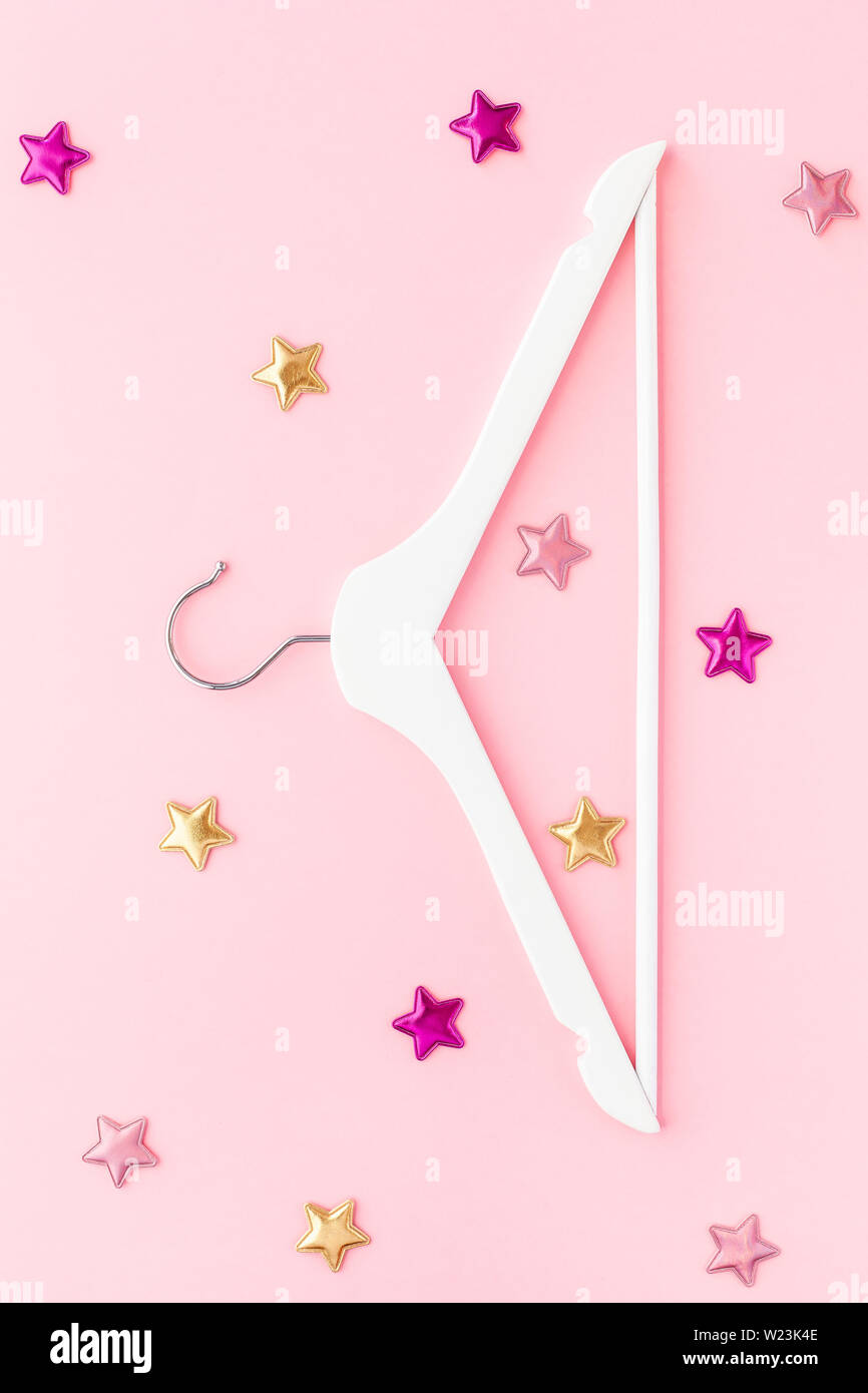 Creative top view flat lay white wooden hangers pastel millennial pink ...