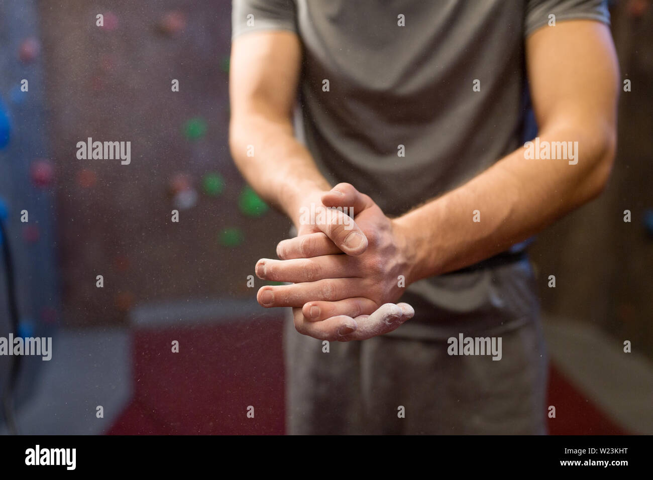 male climber drying hands at indoor climbing gym Stock Photo