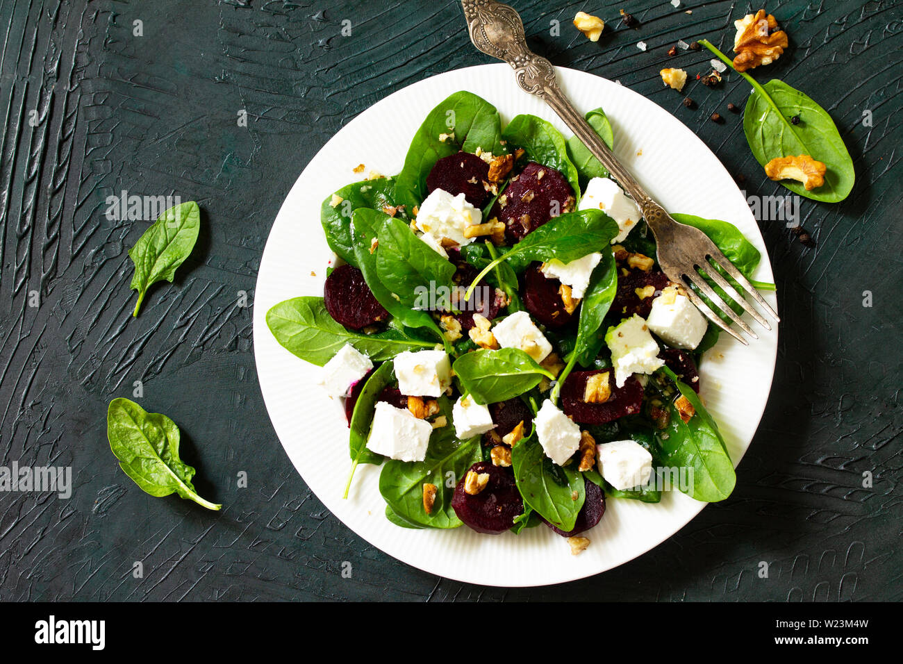 Salad with spinach, feta cheese, beetroot and walnut, vegetable oil