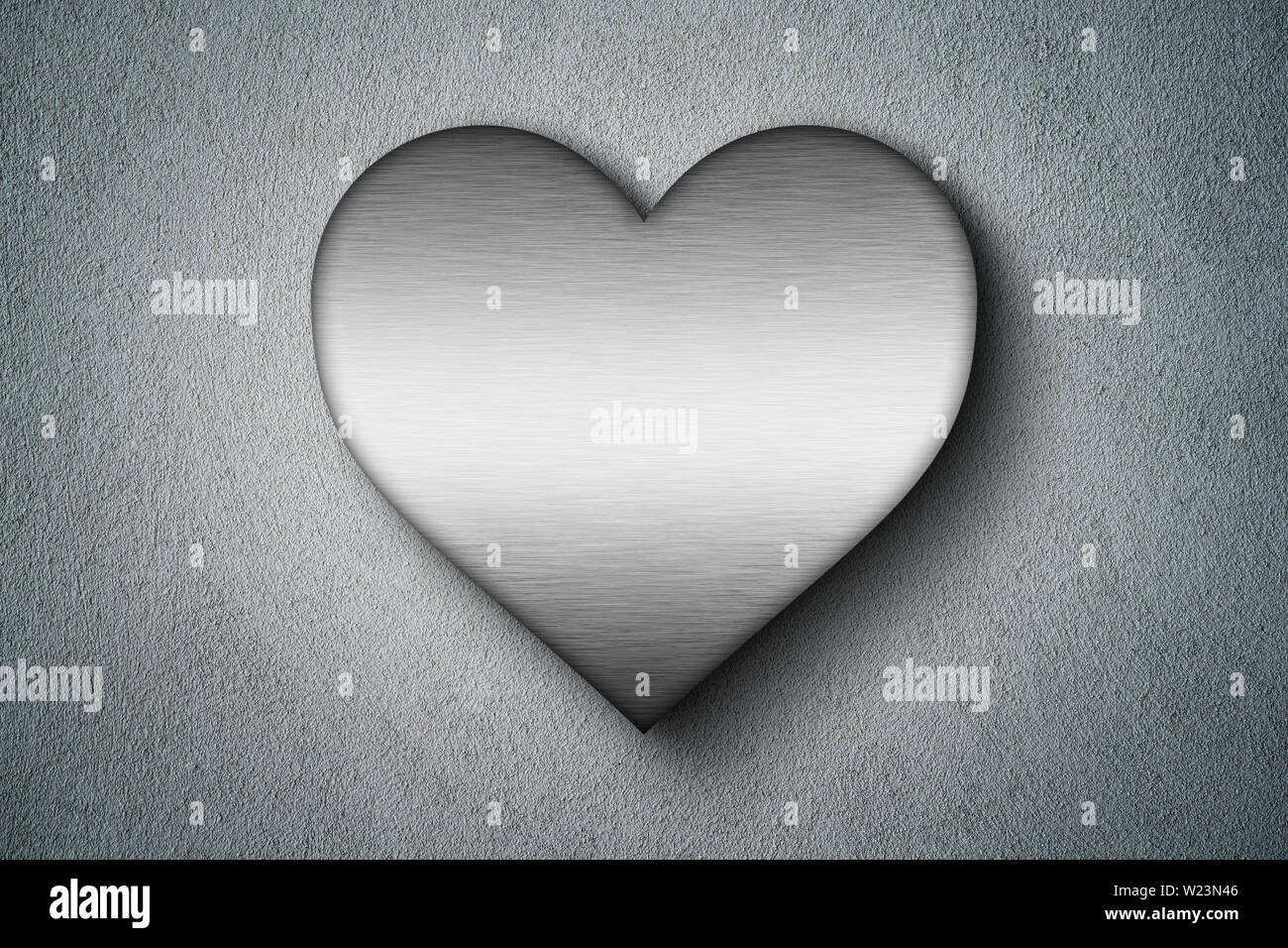 Metal heart shape on concrete wall . Love concept . Stock Photo