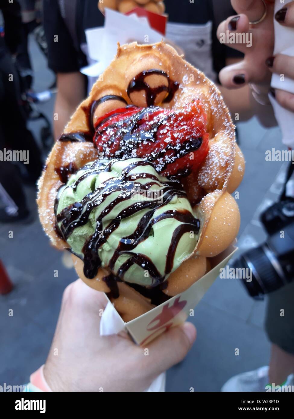 Tourists, at the ChinaTown in London, Soho, travel and eat a nice ice