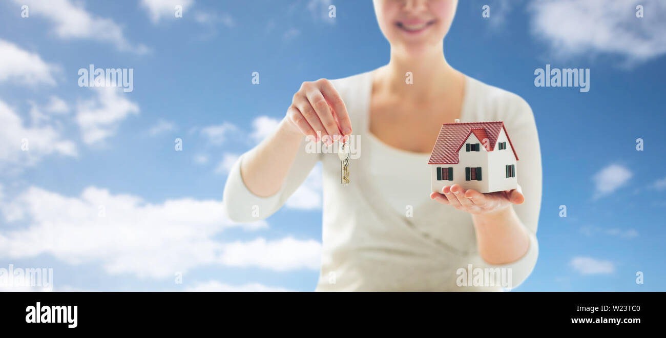 close up of hands holding house model and keys Stock Photo - Alamy