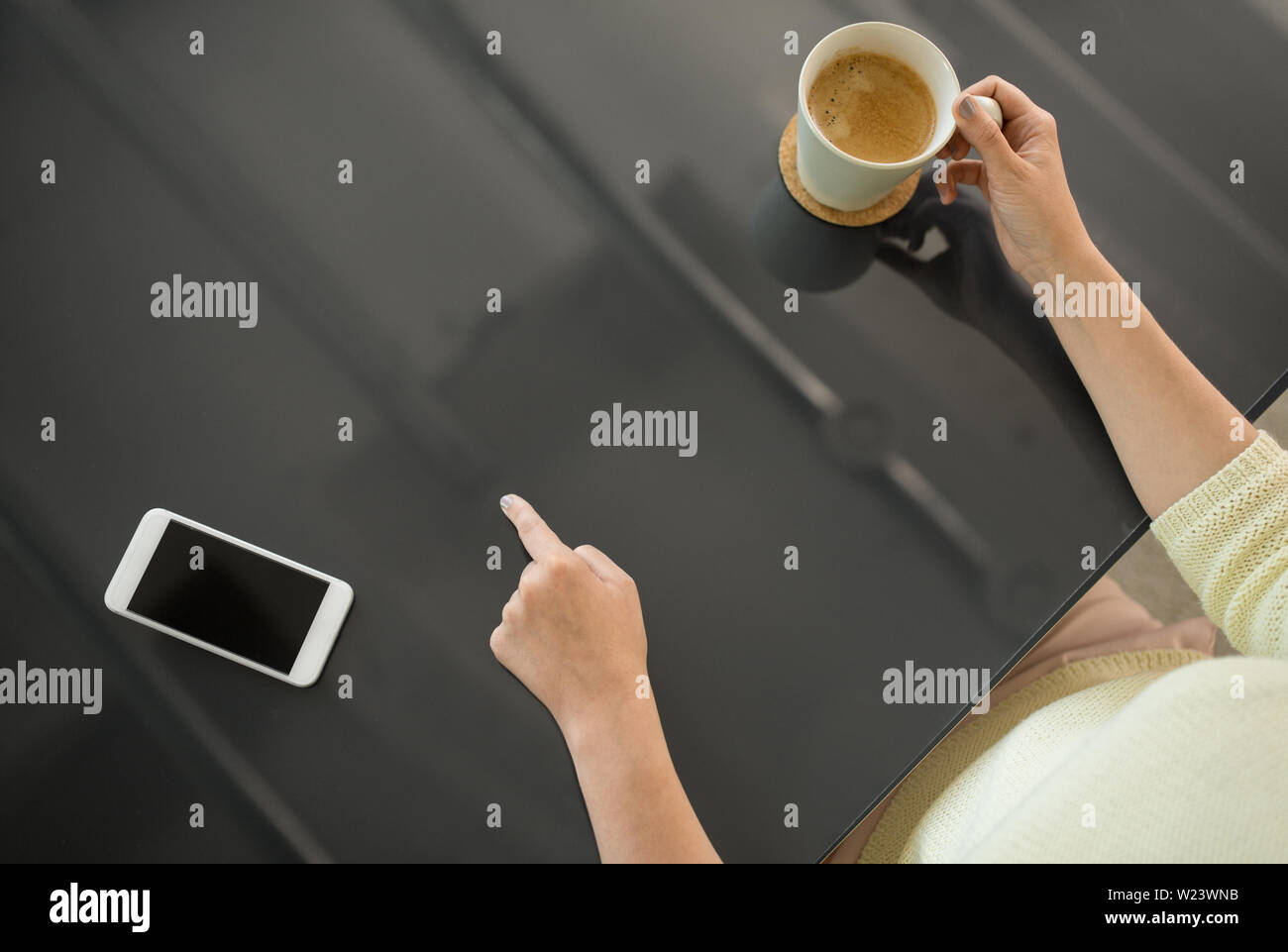 woman with coffee using black interactive panel Stock Photo