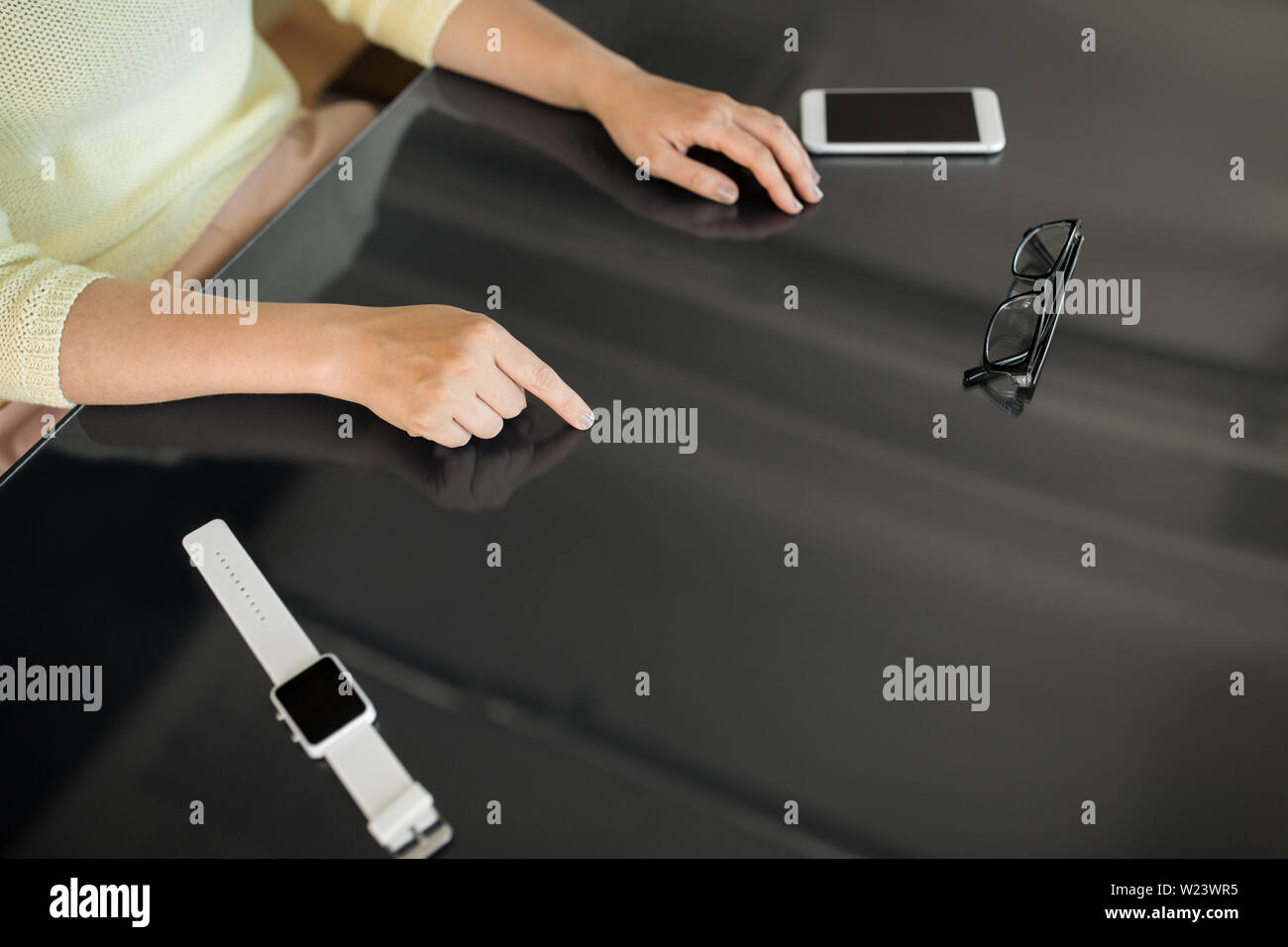 close up of woman using black interactive panel Stock Photo