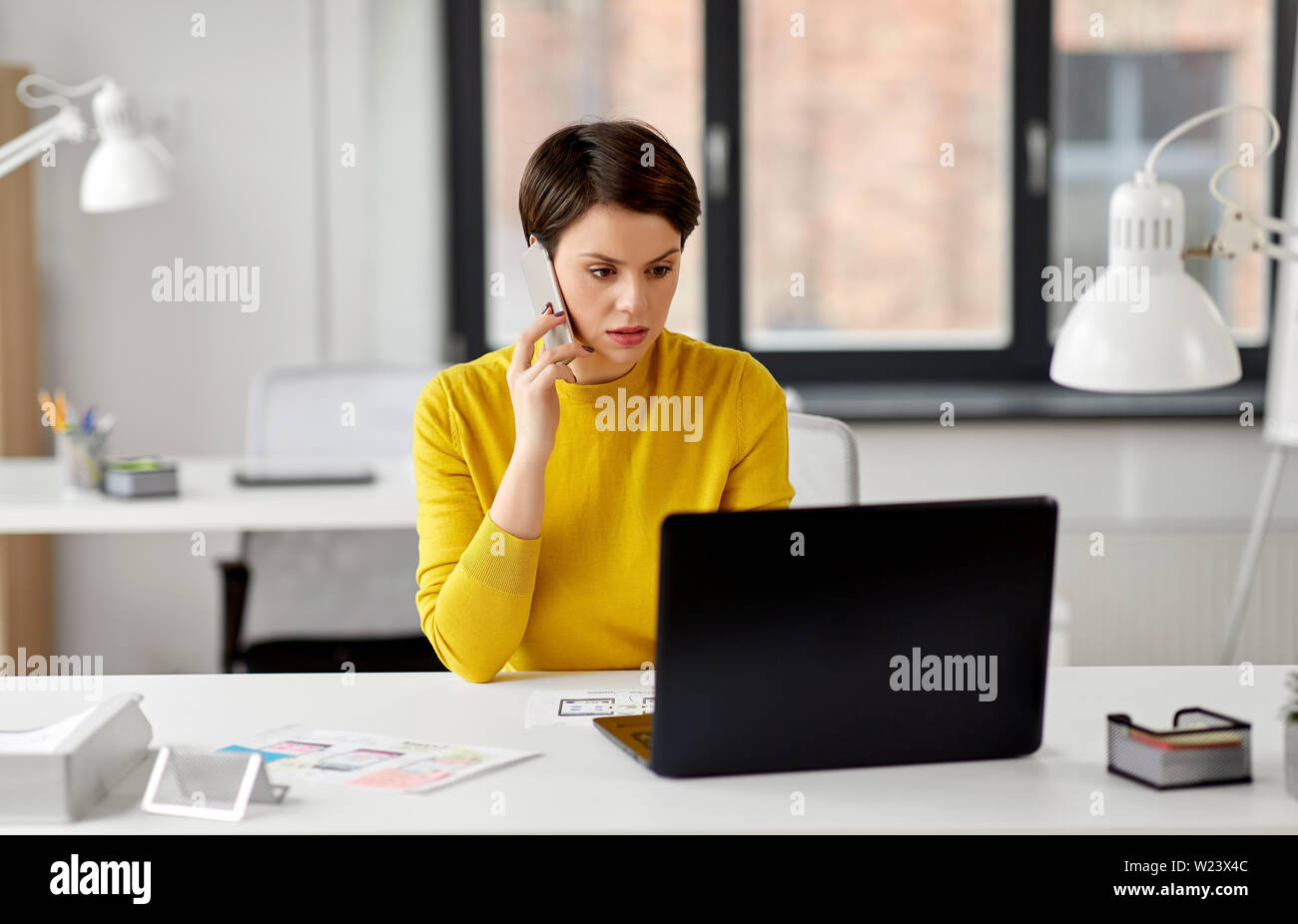 ui designer calling on smartphone at office Stock Photo