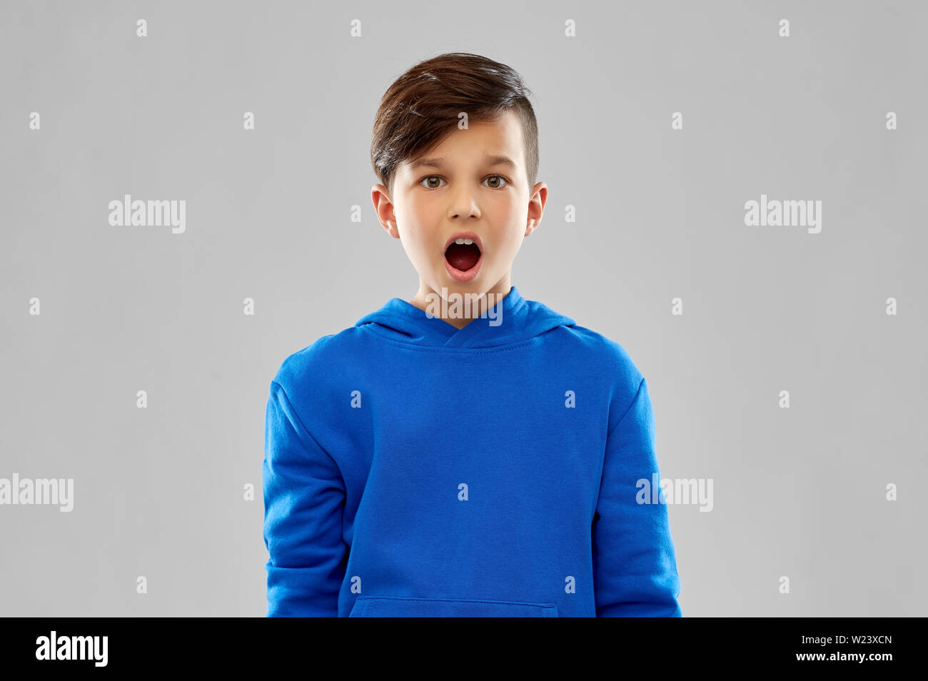 shocked boy in blue hoodie Stock Photo Alamy