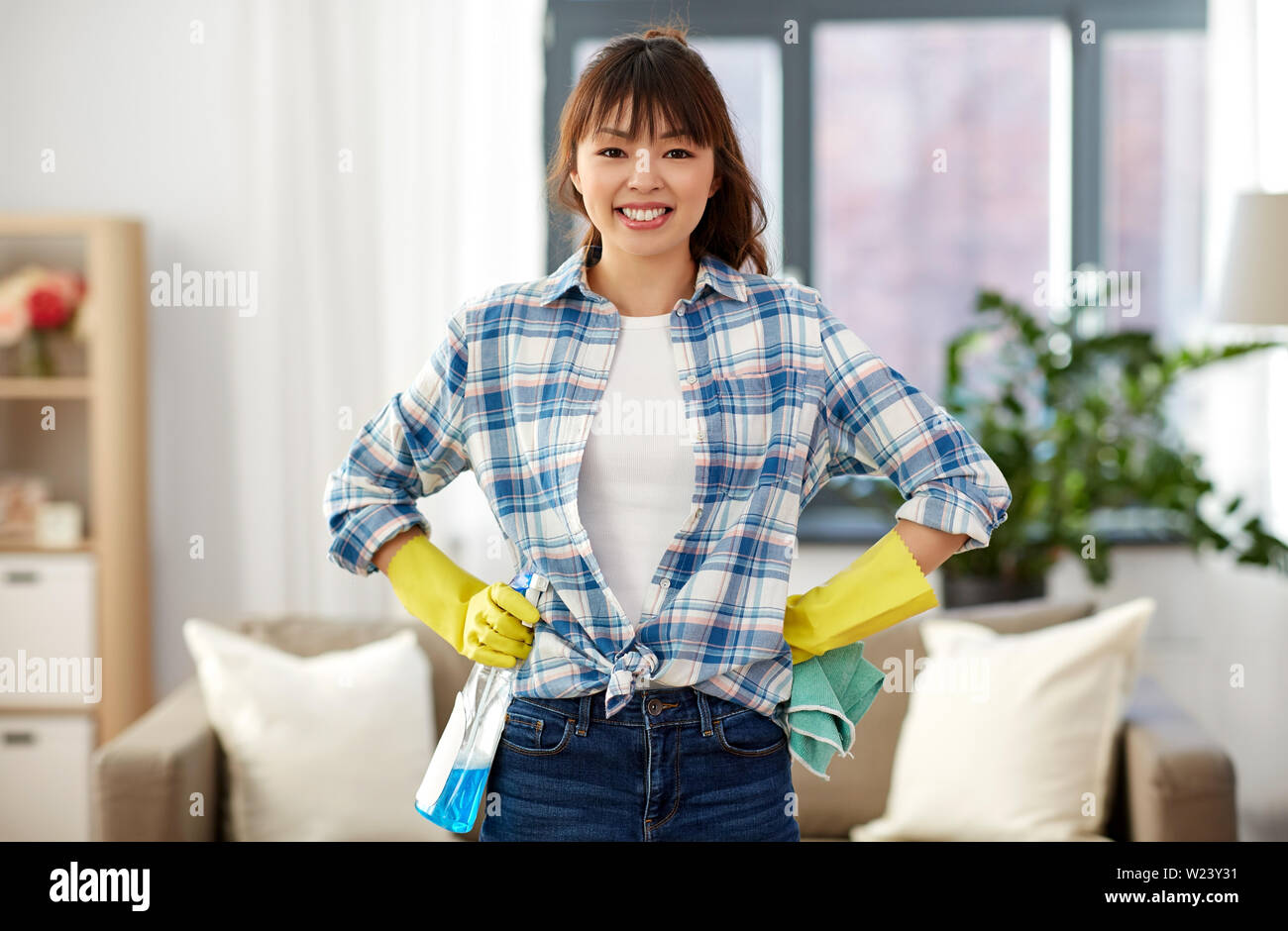 smiling asian woman cleaning at home Stock Photo