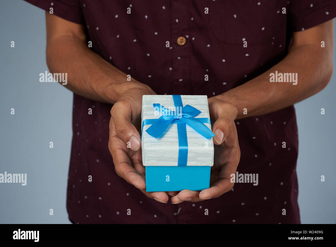 Small gift box in hand close up view. Giving present box Stock Photo