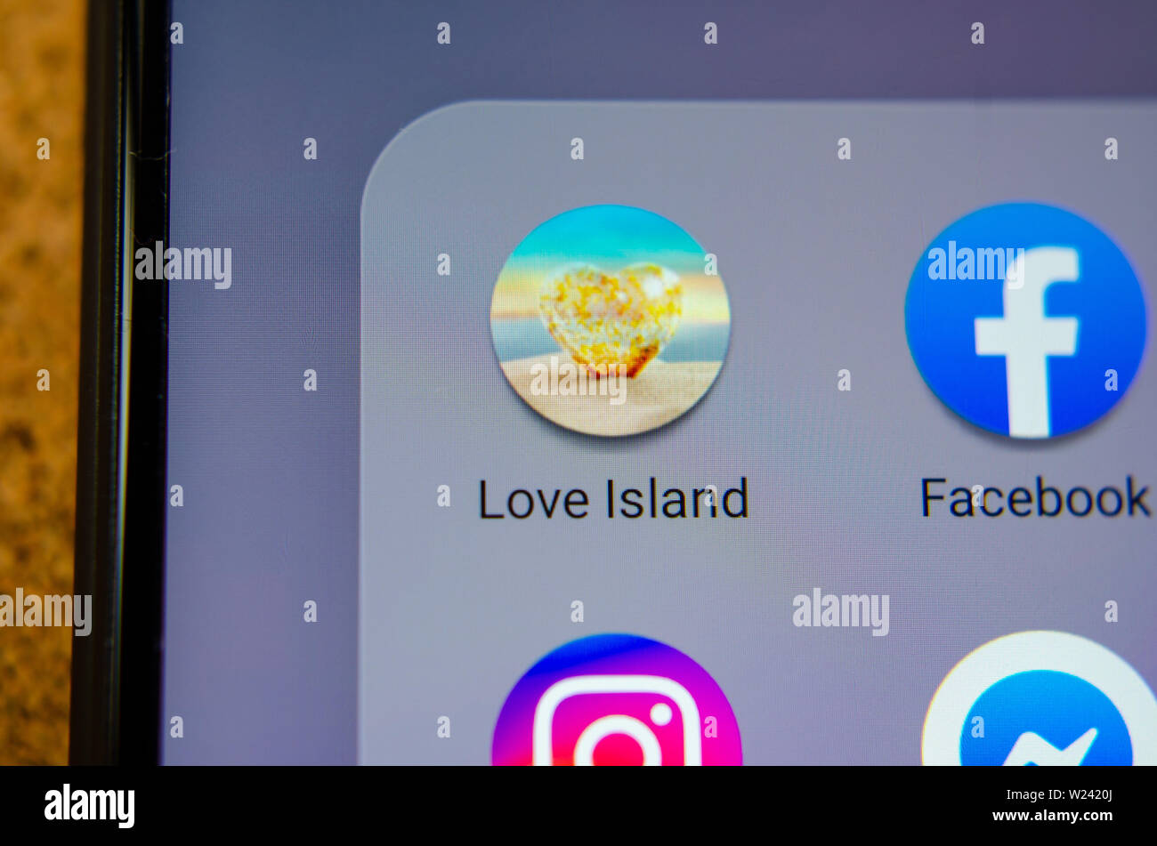Love Island TV show mobile app icon on the smartphone screen. Stock Photo